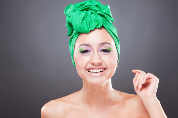 Happy smiling woman with green scarf on head and bright pink-gre - Foto, Imagem