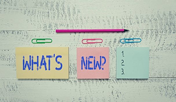Text sign showing What S New Question. Conceptual photo when you ask someone about his current live events actions Multicolor blank notepads clips marker pencil wooden vintage background. - Foto, Imagem
