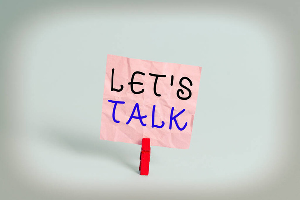 Writing note showing Let S Is Talk. Business photo showcasing suggesting in the beginning of a conversation on the topic Colored clothespin rectangle square shaped paper light blue background. - Photo, Image