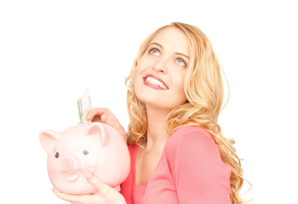 Lovely woman with piggy bank and money - Fotoğraf, Görsel