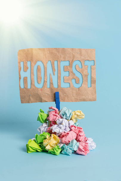 Writing note showing Honest. Business photo showcasing telling the truth or able to be trusted and not likely to steal Reminder pile colored crumpled paper clothespin wooden space. - Photo, Image