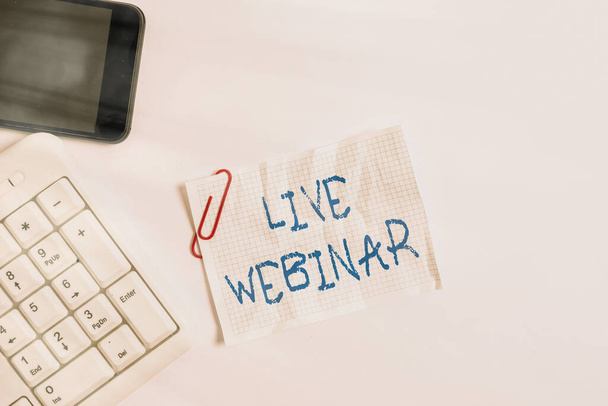 Handwriting text Live Webinar. Concept meaning presentation lecture or seminar transmitted over Web White pc keyboard with empty note paper above white background and mobile phone. - Photo, Image