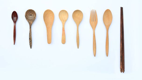 Set wooden spoon, fork and chopstick isolated over white background. Top view - Photo, image