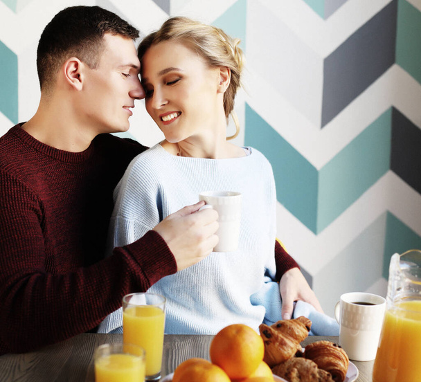 young beautiful couple having breakfast table - Фото, зображення