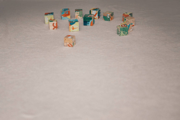 colored cubes on the floor. toys on a white background. Concept of fine motor skills development, educational games, childhood, children's day, kindergarten copyspace - Foto, imagen
