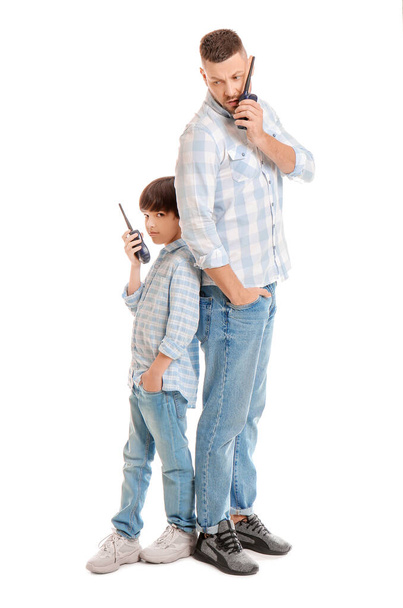 Father and little son with radio transmitters on white background - Photo, Image