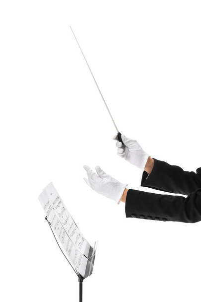 Hands of young female conductor on white background - Photo, Image