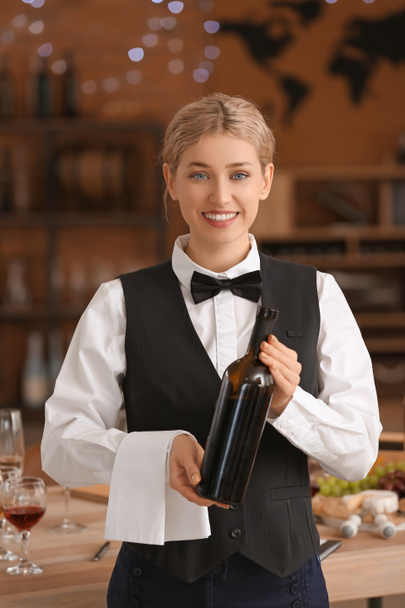 Waiter with bottle of wine at the restaurant - Foto, Bild