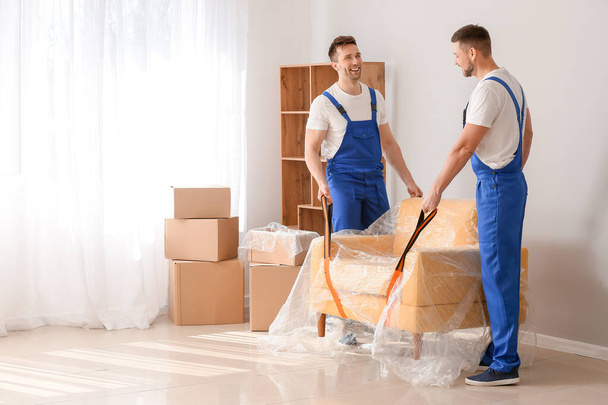 Loaders carrying furniture in flat - Photo, image