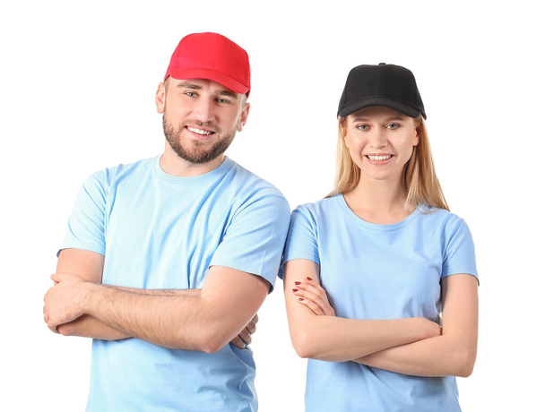 Young couple in stylish caps on white background - Foto, Imagen