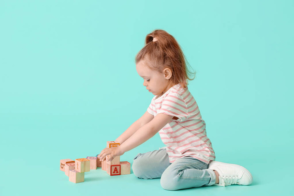 Little girl with toys on color background - Foto, Bild
