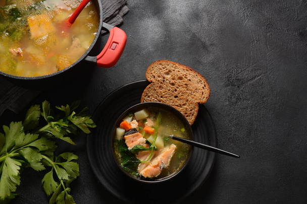 Fresh  fish soup on black background - Photo, image