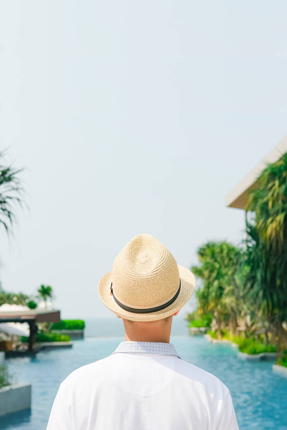 Summer holidays, travel, tourism and vacation concept. Boy in a hat on a beach or near the swimming pool. - Foto, imagen