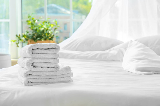 Toallas limpias en la cama en casa
 - Foto, Imagen