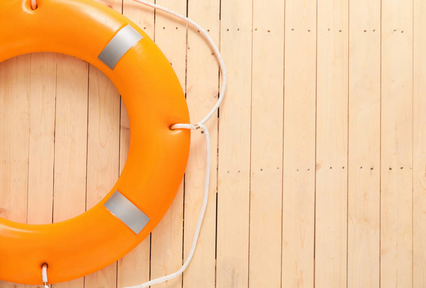 Lifebuoy ring on wooden background - Foto, Imagen