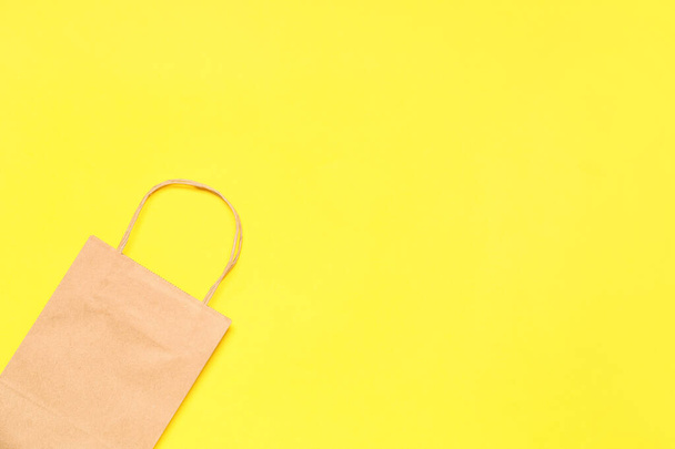 Paper shopping bag on color background - Φωτογραφία, εικόνα