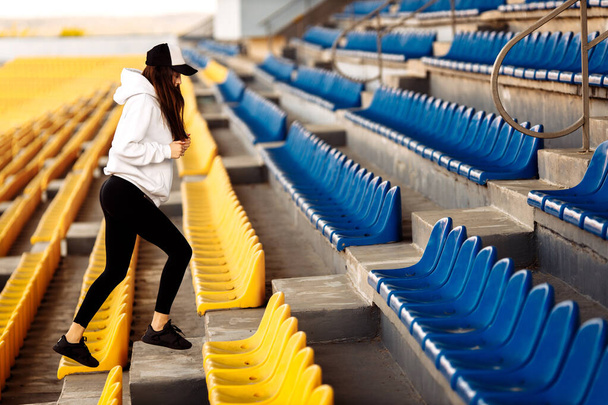 Young fit woman exercising on stadium  - Foto, Bild
