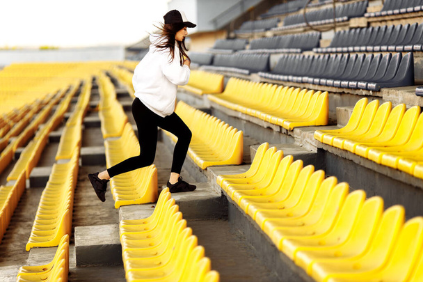 Young fit woman exercising on stadium  - Fotografie, Obrázek