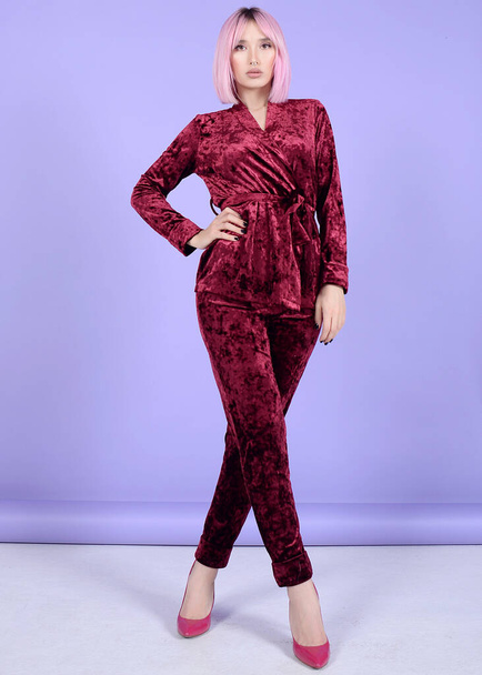 beautiful girl on colored backgrounds in silk and velvet pajamas and home costume - 写真・画像