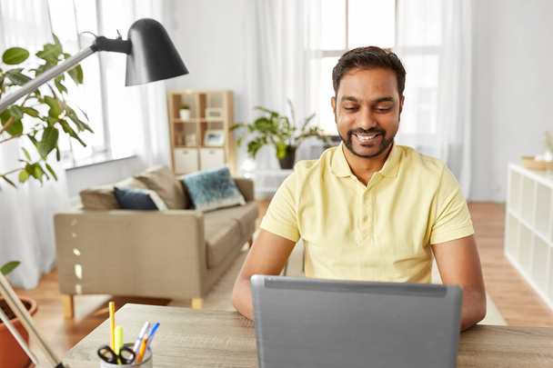 indian man with laptop working at home office - Foto, Imagem