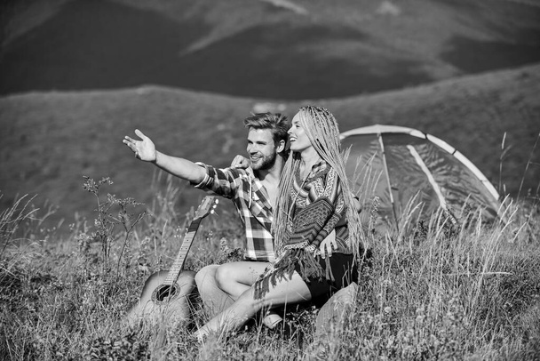 Hiking romance. Camping in mountains. Family travel. Summer vacation. Boyfriend girlfriend guitar near camping tent. Couple in love happy relaxing nature background. Love concept. Camping vacation - Foto, Bild