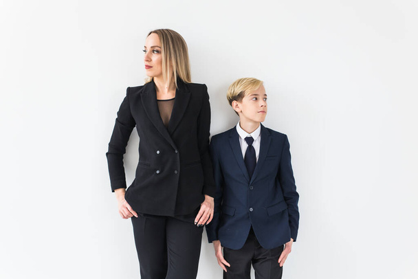 Parenting, family and single parent concept - A happy mother and teen son smiling on white background. - Foto, Bild
