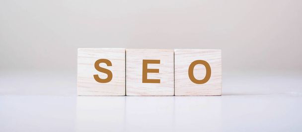 SEO (Search Engine Optimization) text wooden cube blocks on table background. Idea, Vision, Strategy, Analysis, Keyword and Content concept - Photo, Image
