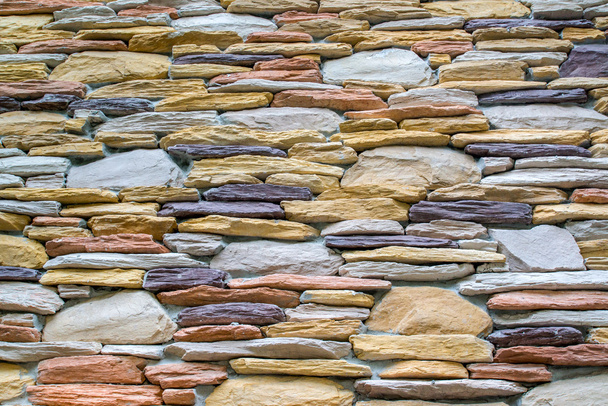 Layers of colorful stones wall as texture in landscape view - Photo, Image