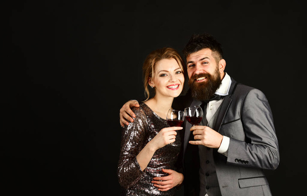Man with beard and woman in shining dress celebrate - Foto, Imagen