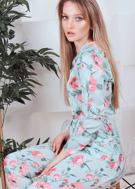 beautiful Russian girl with blue eyes at home in silk satin pajamas with lace - Zdjęcie, obraz