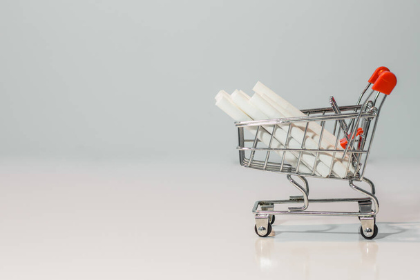 Close up cigarette on mini shopping cart on white background  with copy specs - Photo, Image
