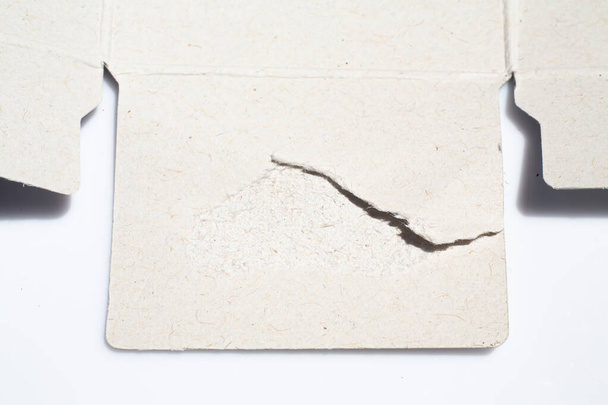 Caixa de papel de embalagem rasgada usada no fundo branco, Fechar e macro tiro, Foco seletivo, Transporte, Conceito de embalagem
 - Foto, Imagem