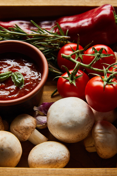 delicious tomato sauce in bowl near fresh ripe vegetables, rosemary and mushrooms - Photo, Image