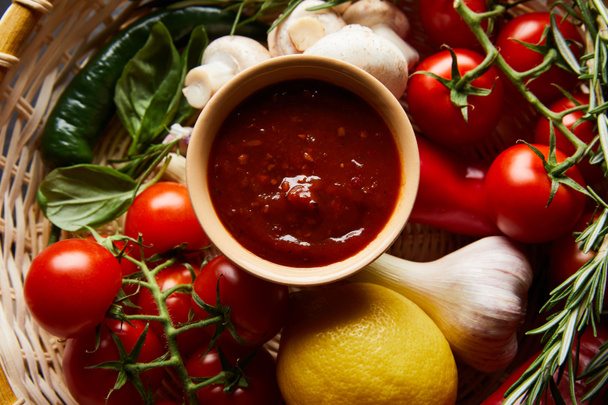 top view of delicious tomato sauce with fresh ripe vegetables in basket - Φωτογραφία, εικόνα