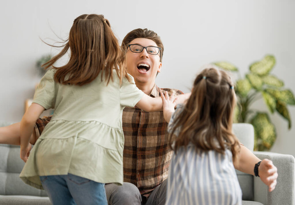 Happy loving family. Daddy and his daughters children girls playing together. Father's day concept. - Foto, Imagem