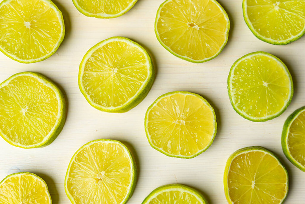 Lime slices on wooden surface - Foto, immagini
