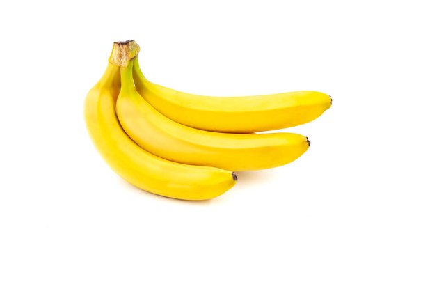 Three bananas isolated on white background. Banana bunch. Creative healthy food concept. Flat lay. - Fotó, kép