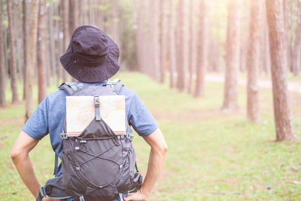 Asian man with backpack hiking in forest , Adventure Travel Remote Relax Concept - Photo, Image