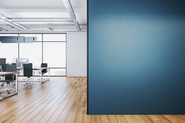 Clean coworking office interior with equipment on desktop, city view and blank blue wall.  Workplace and corporate concept. 3D Rendering - 写真・画像