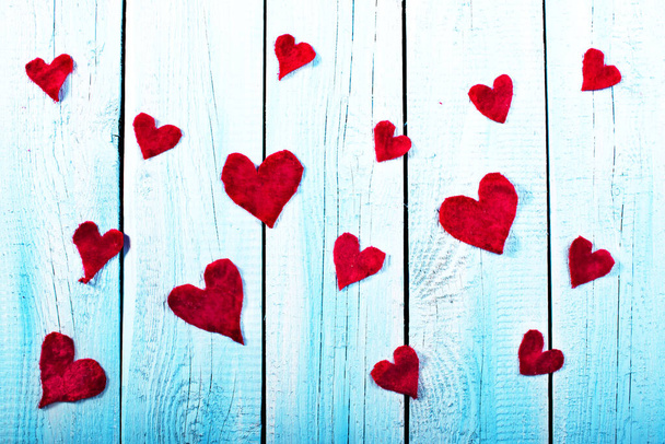 Piros textil szív fa rusztikus deszkán, kék színben. Anyák napja, Valentin-nap, szerelem, romantika. - Fotó, kép