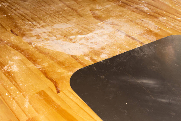 pizza shovel on cutting board full of flour. - Photo, Image
