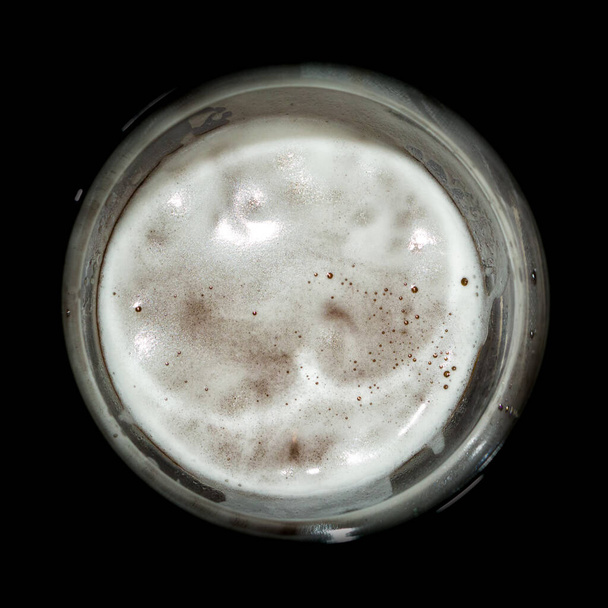 beer foam in the glass shot from above. - Photo, Image