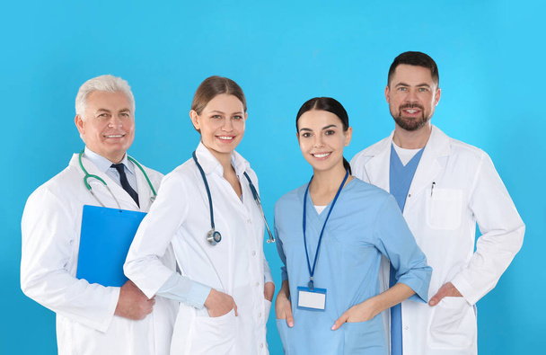 Group of doctors against blue background. Medical service - Zdjęcie, obraz