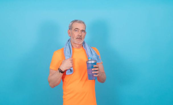 portrait of adult man with sportswear isolated on color background - Zdjęcie, obraz