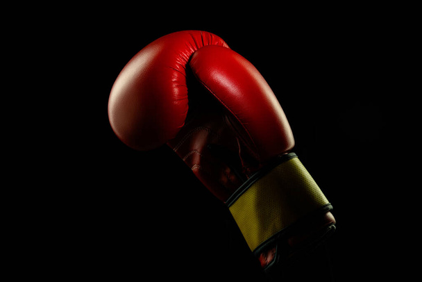 Professional sport equipment isolated on black studio background. Boxers red glove. - Фото, зображення