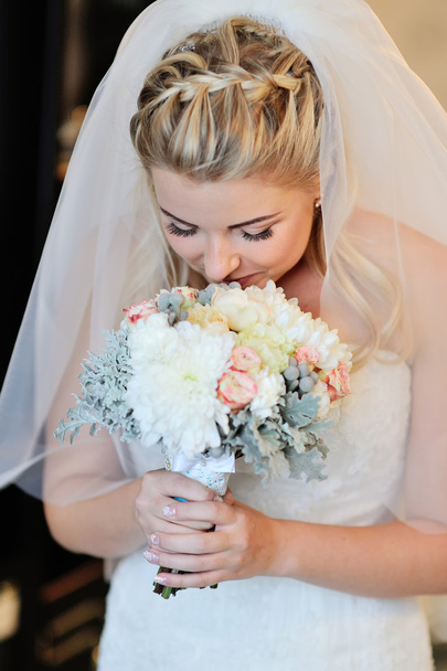 Happy bride smelling bridal bouquet - Photo, Image