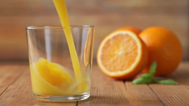 Slow Motion Shot of Fresh Orange Juice Being Poured in a Glass. - Filmagem, Vídeo