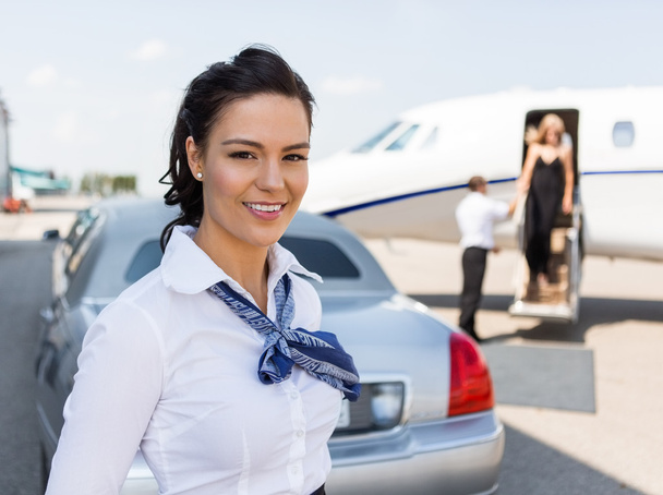 Beautiful Stewardess Standing Against Limousine And Private Jet - Zdjęcie, obraz