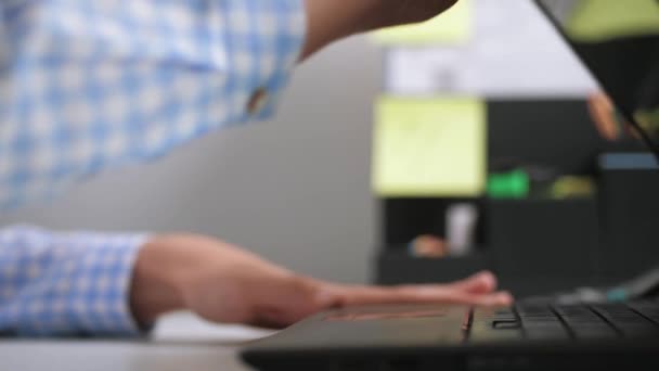 Жіноча рука відкриває обкладинку ноутбука на робочому місці, вмикає комп'ютер і починає працювати на клавіатурі
 - Кадри, відео