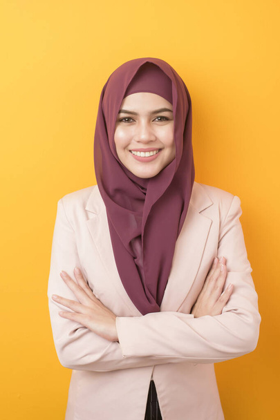 Beautiful business woman with hijab portrait on yellow background  - Foto, imagen